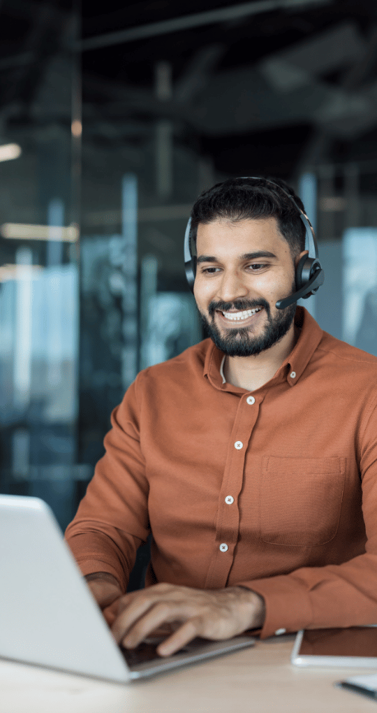 Technical Support Man Smiling on Computer