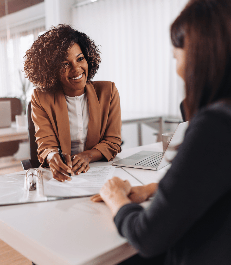 Professional Woman Signing Papers in Bank Branch