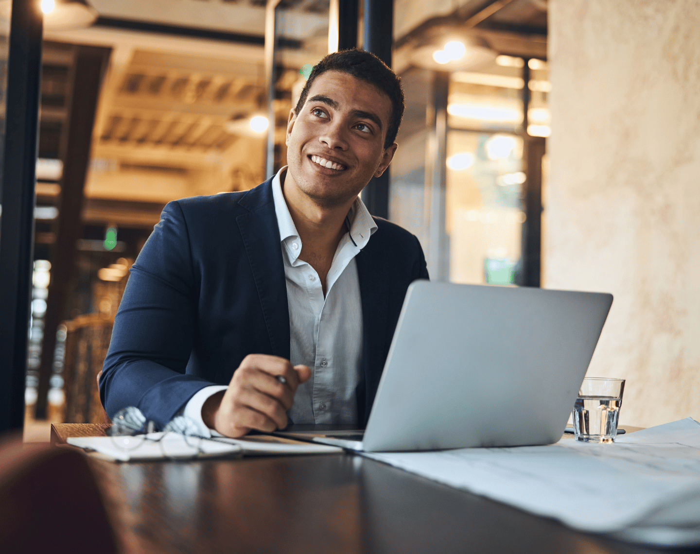 Young Executive Day Dreaming and Smiling in Office
