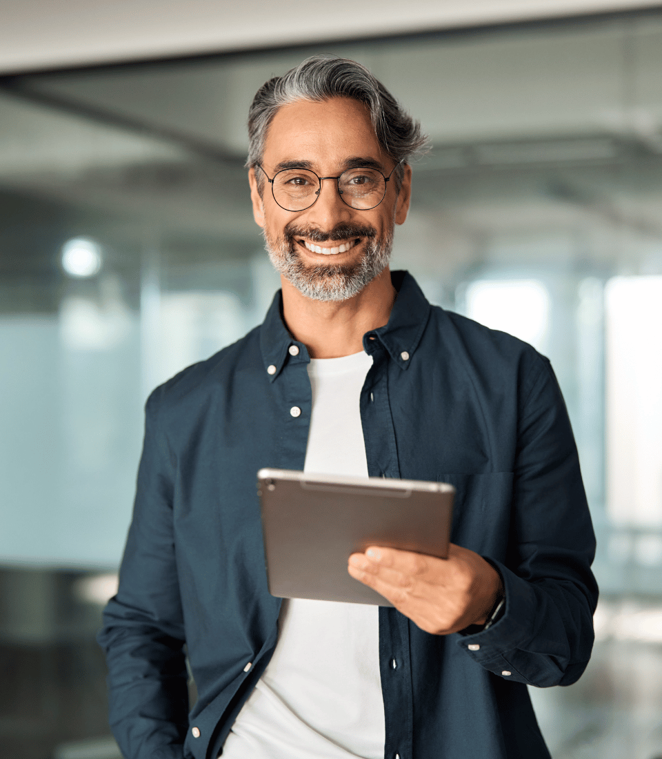 Middle Aged Man on Tablet Smiling