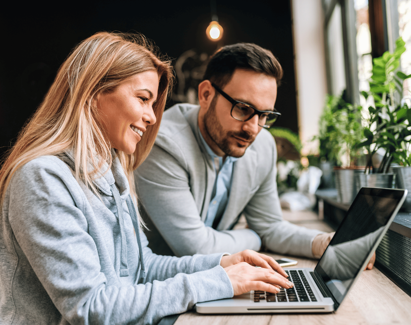 Man and Woman Professionals Looking at Laptop