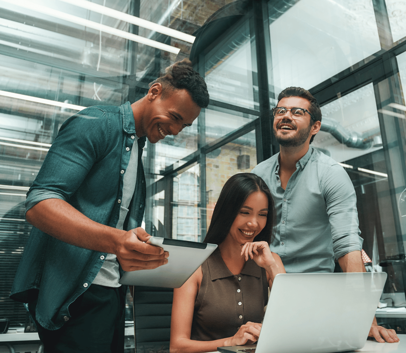 Young Professional Team in a Modern Office Smiling Looking at Computer