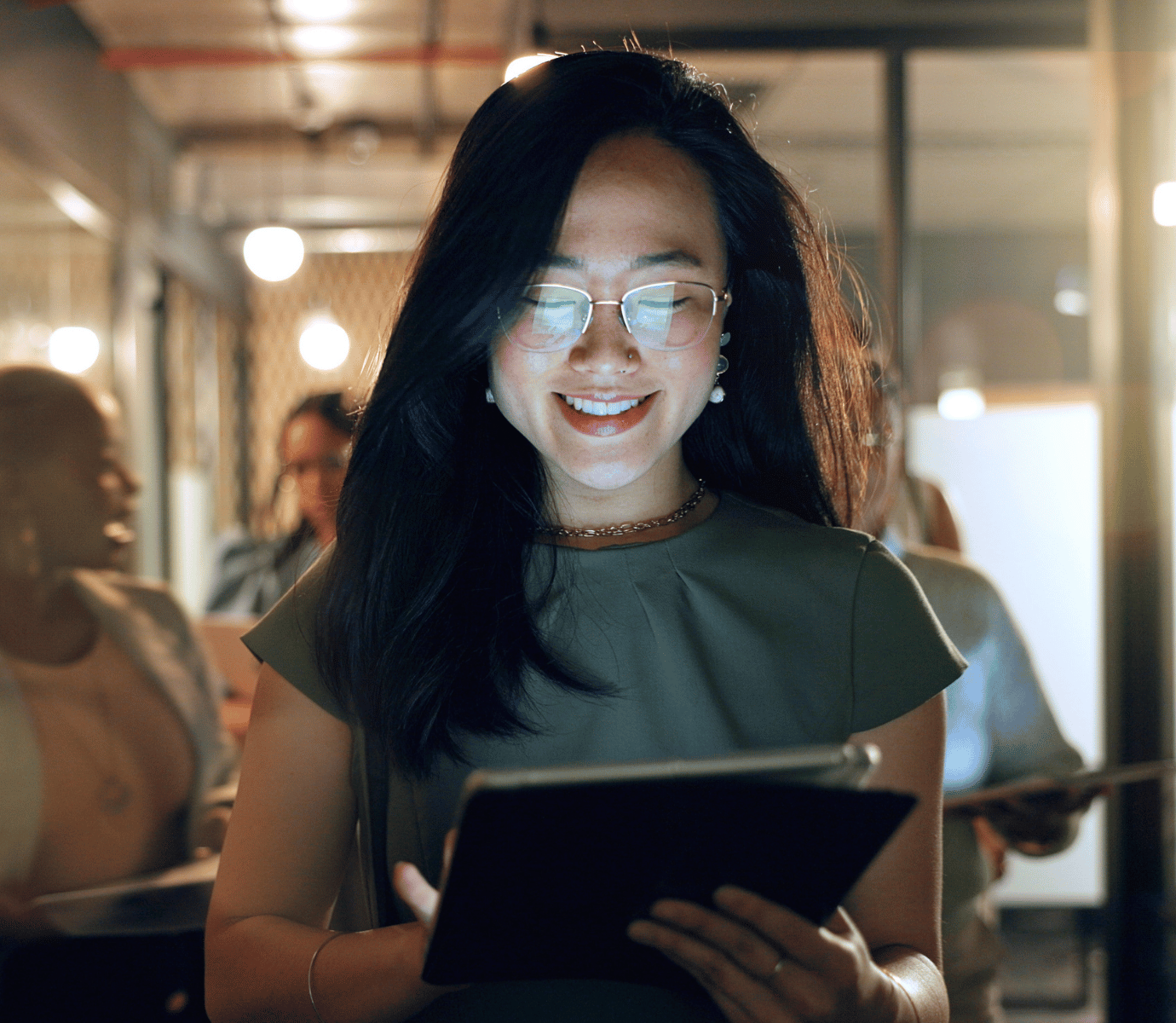 Woman on iPad at Night with Screen Glowing in Face