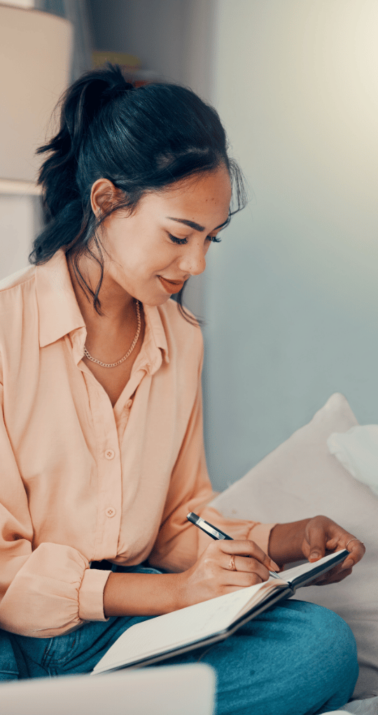 Woman Taking Notes While Sitting Down