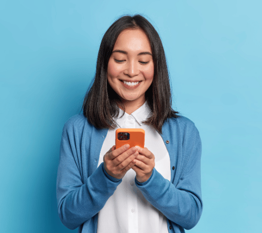 Woman Smiling on Phone with Orange Case