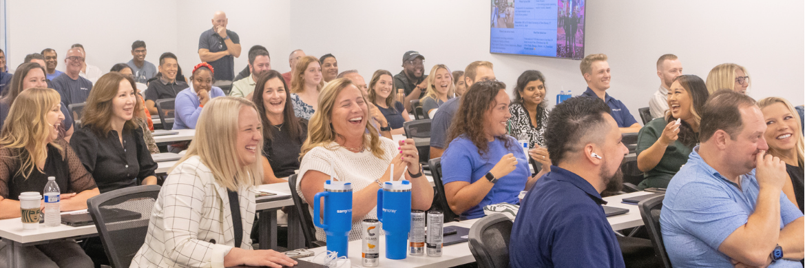 The SavvyMoney Team Laughing in a Conference Room
